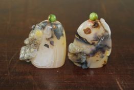 Two Chinese agate figural snuff bottles, each carved in relief with an ornamental fish and a