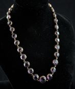 An Edwardian gold and amethyst spectacle set choker necklace, set with thirty two graduated