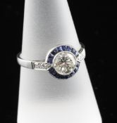 A platinum sapphire and diamond cluster ring, with diamond set shoulders and central diamond
