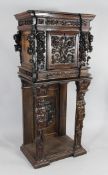 A 19th century Italian carved walnut cabinet on stand, with cherub faces, scrolling acanthus