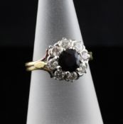 A 1970`s 18ct gold, sapphire and diamond cluster ring, size K.