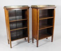 A pair of mahogany and satinwood inlaid open bookcases, with pierced brass gallery backs and tapered