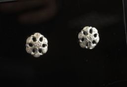 A pair of 18ct white gold and diamond ear studs, of flower head design.