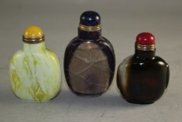 Three Chinese hardstone snuff bottles, including an example in fluorite, brown stained quartz and