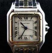 A gentleman`s steel and gold Cartier Santos quartz wrist watch, with Roman dial and date aperture.
