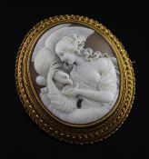 A late Victorian gold mounted oval cameo brooch, carved with Hebe and the Eagle, with cannetile work