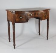 An early 19th century mahogany bow front sideboard, with three drawers, on ring turned legs, W.3ft