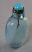 A Chinese pale blue glass snuff bottle, 6.4cm., stopper