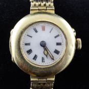 A lady`s early 20th century Swiss 18ct gold wrist watch on a 15ct gold gatelink bracelet, with Roman