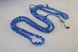 A Chinese translucent blue glass bead mahler, 25in. drop