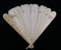 A 19th century French ivory brise fan, the guards carved with scrolling flowers, 9in.