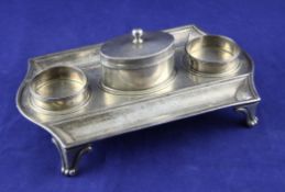 A George III silver inkstand, by Paul Storr, of shaped rectangular form, with two pen and two well