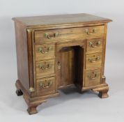 An 18th century walnut kneehole desk, with brass swan neck handles, on ogee bracket feet, W.2ft