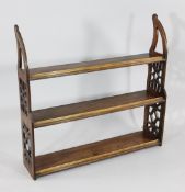 A set of 19th century mahogany hanging shelves, with pierced sides, W.2ft 11in.