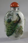 A large Chinese inside painted glass snuff bottle, decorated with a peacock and hen perched in trees