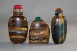Three Chinese tigers eye quartz snuff bottles, one carved in relief with a tiger, 4.7cm, the other