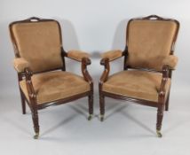 A pair of William IV mahogany open armchairs, with buttonback and padded scrolling arms, on reeded