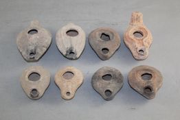 Eight Roman pottery oil lamps, 2nd-4th century A.D., of varying forms and sizes, largest 4.5in.