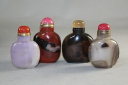 A Chinese green jade flattened snuff bottle, the stone with russet inclusions, 6.7cm., stopper