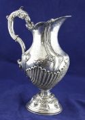 An early 19th century Spanish? silver pedestal ewer, of baluster form, with engraved, scroll and "