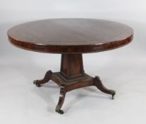A Regency mahogany and rosewood banded circular breakfast table, with tilt top, on square tapered