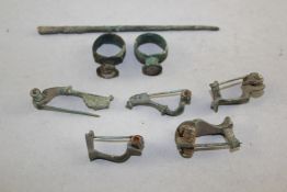 Five Roman bronze fibula brooches, two seal top rings and a tool, 1st-2nd century A.D.