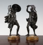 A pair of 19th century bronze figures of Roman warriors, standing with shields and swords, on Sienna