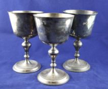 A set of three large late George II Scottish silver chalices, with tapering bowls and turned