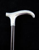 A late 19th century silver topped walking cane, with scrolled handle and leaf decoration,