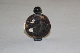 A Chinese tortoiseshell snuff bottle, overlaid in bone with birds amid flowers and rockwork, 6cm.