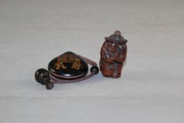 A Chinese wood snuff bottle, carved as a kneeling fisherman grasping a fish, 6cm. incl. stopper,