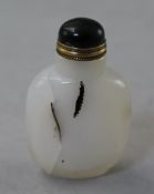 A Chinese agate snuff bottle, with black shadow inclusions, 5.5cm., stopper