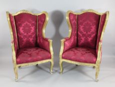 A pair of Louis XV design gilt framed fauteuils, with damask upholstery