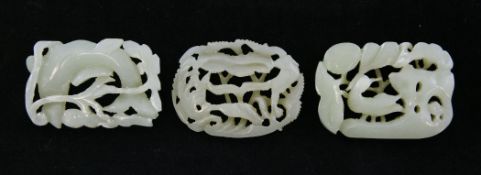 Three pale celadon jade plaques, 17th century or earlier, each pierced and carved with a bird and
