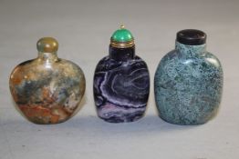 Three Chinese hardstone snuff bottles, the first moss agate, the second amethyst quartz and the last