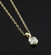 A modern 18ct gold and solitaire diamond pendant, on a 9ct gold fine link chain, 16in.