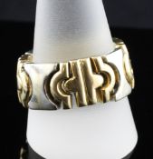 A modern continental 18ct two colour gold articulated ring, stamped 750, 17 grams, size V.