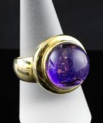 A modern continental 14ct gold and cabochon amethyst set dress ring, gross 17.3 grams, size R.