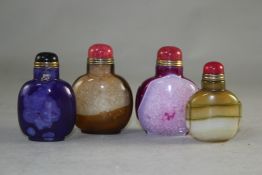 Four Chinese stained agate snuff bottles, in green, purple, caramel and rose colours, largest