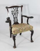 An 18th century Irish mahogany open armchair, with carved scrolling eagle head arm rests, acanthus