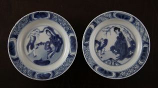 A pair of Chinese blue and white saucer dishes, Kangxi period, each painted to the centre with a