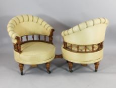 An Edwardian satinwood conversation seat, with a pair of revolving tub shaped armchairs, on turned
