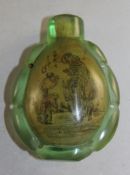 A Chinese inside painted green glass snuff bottle, painted with figures in landscapes, inscribed,