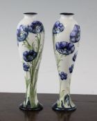 A pair of Moorcroft MacIntyre Florian Ware Poppy and Daisy pattern slender baluster vases, with a
