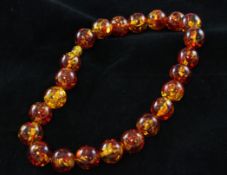 An amber necklace, composed of twenty three 12mm beads