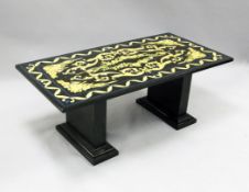 A black slate rectangular coffee table, decorated with acanthus scrolls and floral motifs, on