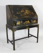 An early 20th century black and gold lacquer chinoiserie bureau, with fall front and single