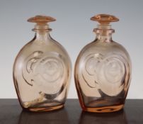 A pair of Art Deco Moser amber tinted glass decanters and stoppers, each of inverted tear drop