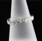 An 18ct white gold and diamond full eternity ring, with twenty one stones in total weighing