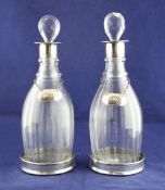 A pair of early Victorian provincial silver mounted glass mallet shaped decanters and stoppers, with